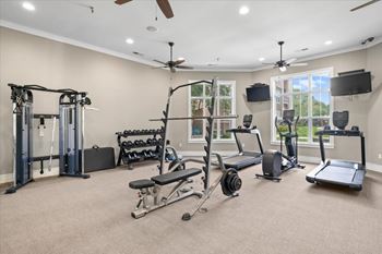 A spacious home gym with a variety of exercise equipment.